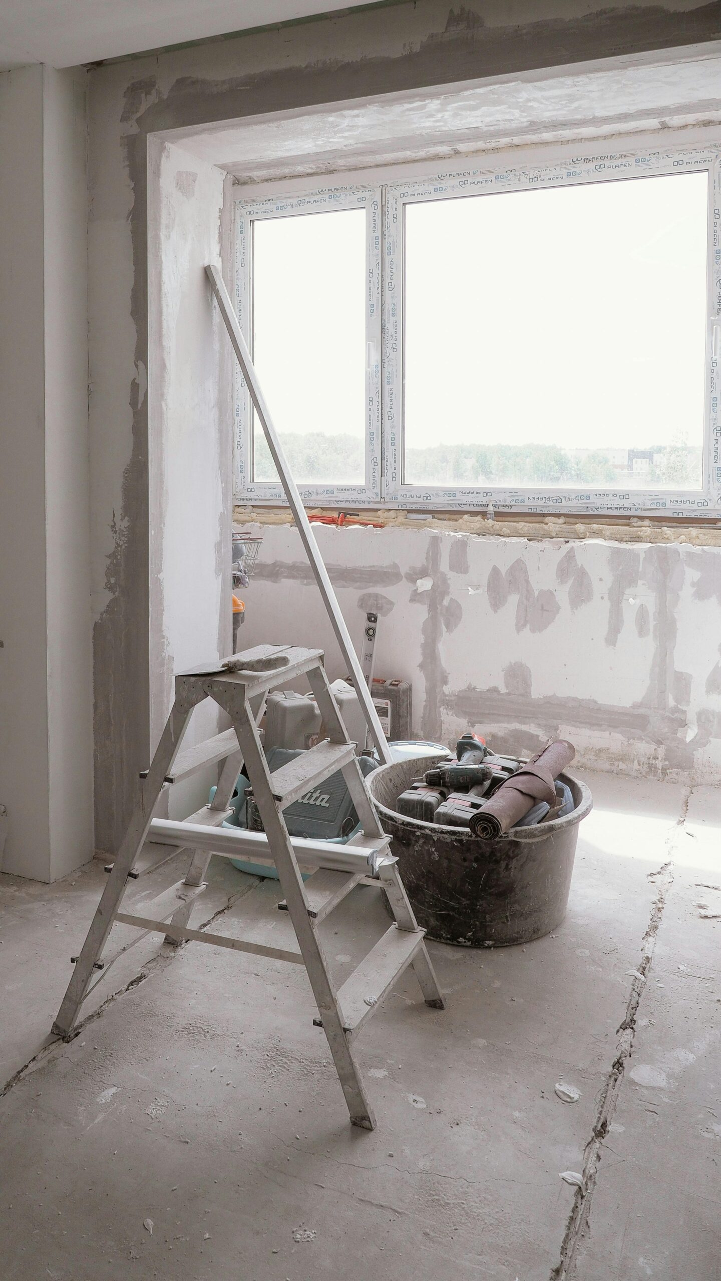 Sunlit room under renovation with tools and ladder, embodying modern DIY projects